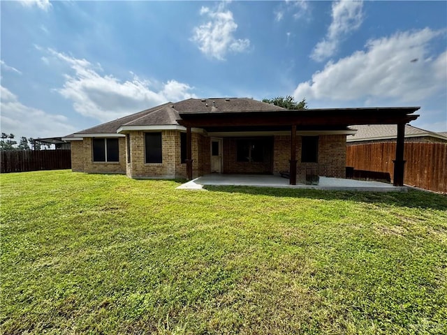1311 Anahi St, Alamo, TX 78516 - back of house with a patio, brick siding, and roof with shingles