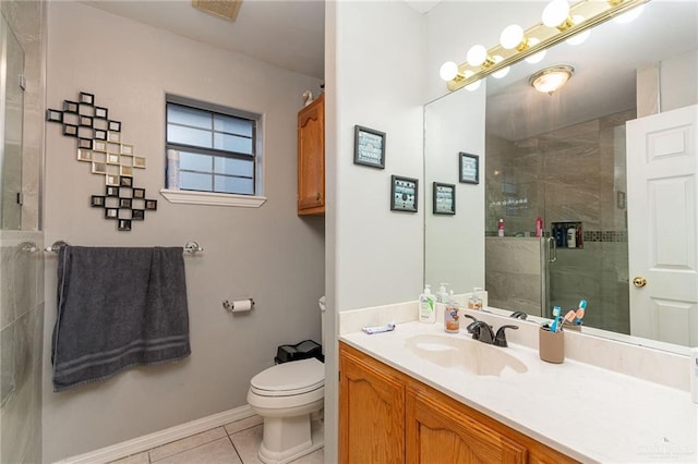 bathroom with tile patterned floors, vanity, an enclosed shower, and toilet