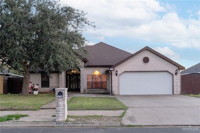 view of front facade with a front lawn and a garage