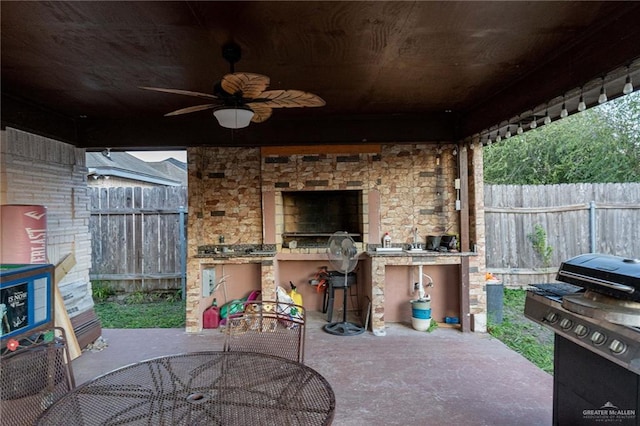 view of patio with ceiling fan and a grill