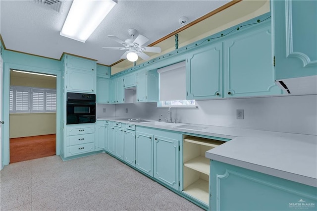 kitchen featuring black oven, ceiling fan, and blue cabinets