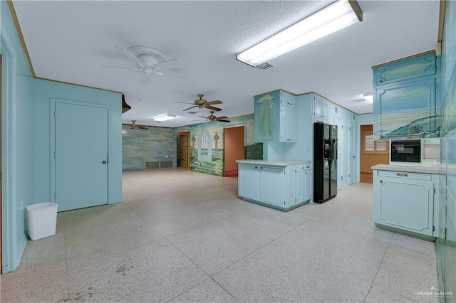 kitchen featuring black refrigerator with ice dispenser, ceiling fan, and a textured ceiling