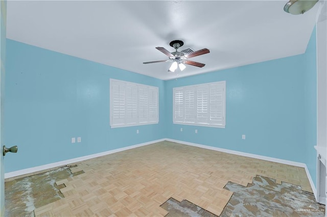 unfurnished room featuring ceiling fan and light parquet floors