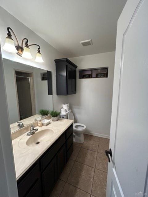 bathroom with vanity, tile patterned floors, and toilet