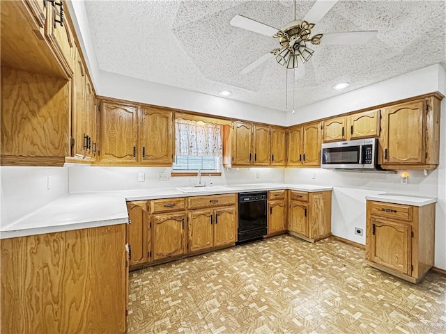 kitchen featuring ceiling fan, dishwasher, a textured ceiling, and sink