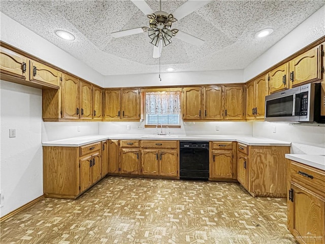 kitchen with a textured ceiling, dishwasher, ceiling fan, and sink