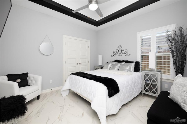 218 Stella Dr, San Juan, TX 78589 - bedroom with light marble finish flooring, a closet, baseboards, and a ceiling fan