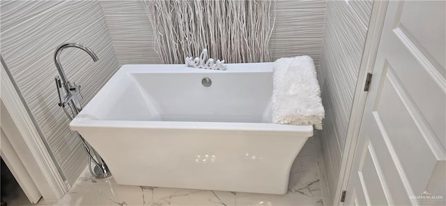 218 Stella Dr, San Juan, TX 78589 - full bathroom with marble look tiles, a freestanding tub, and wallpapered walls