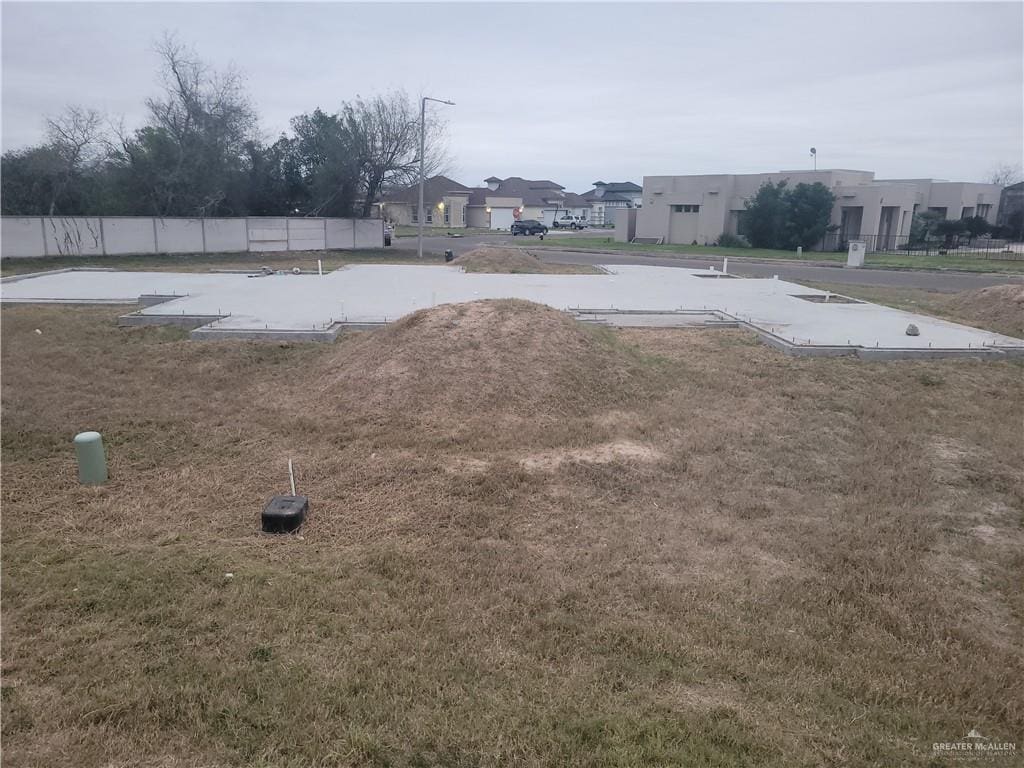 view of storm shelter with a residential view and fence