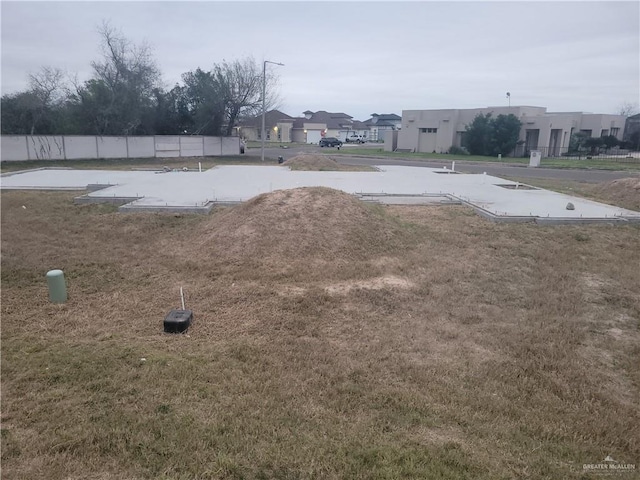 view of storm shelter with a residential view and fence