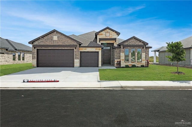 view of front of property featuring a garage and a front lawn