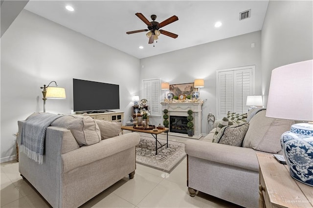3313 Cornell Ave, Mcallen, TX 78504 - living room featuring a ceiling fan, light tile patterned floors, a glass covered fireplace, recessed lighting, and a towering ceiling