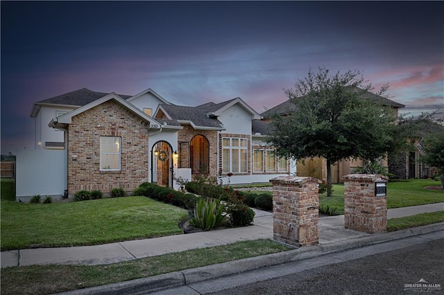 3313 Cornell Ave, Mcallen, TX 78504 - view of front of property featuring a lawn, brick siding, and stucco siding