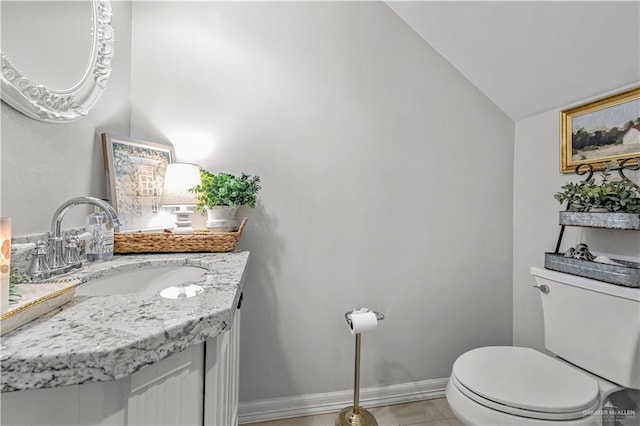 3313 Cornell Ave, Mcallen, TX 78504 - bathroom featuring vaulted ceiling, toilet, vanity, baseboards, and tile patterned floors