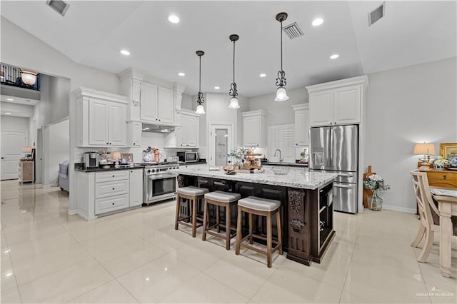 3313 Cornell Ave, Mcallen, TX 78504 - kitchen with stainless steel appliances, backsplash, white cabinets, a kitchen island, and recessed lighting