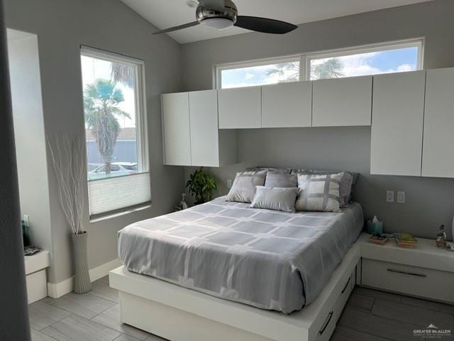 572 Sand Dollar Dr, Port Isabel, TX 78578 - bedroom featuring multiple windows, vaulted ceiling, and a ceiling fan