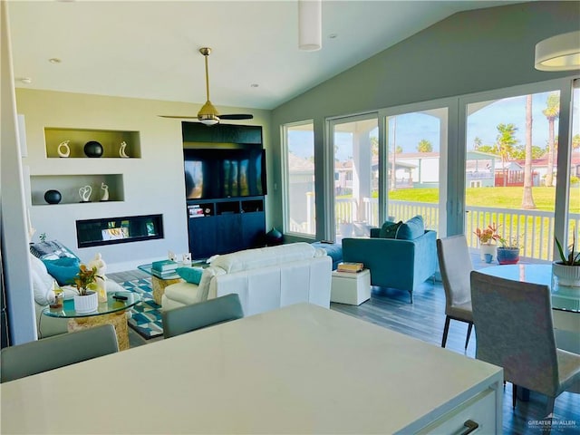 572 Sand Dollar Dr, Port Isabel, TX 78578 - dining area with vaulted ceiling, wood finished floors, built in features, and ceiling fan