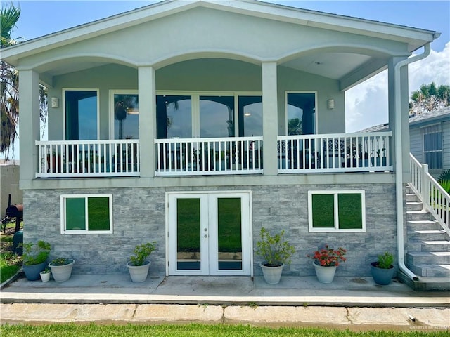 572 Sand Dollar Dr, Port Isabel, TX 78578 - rear view of property featuring stone siding and french doors