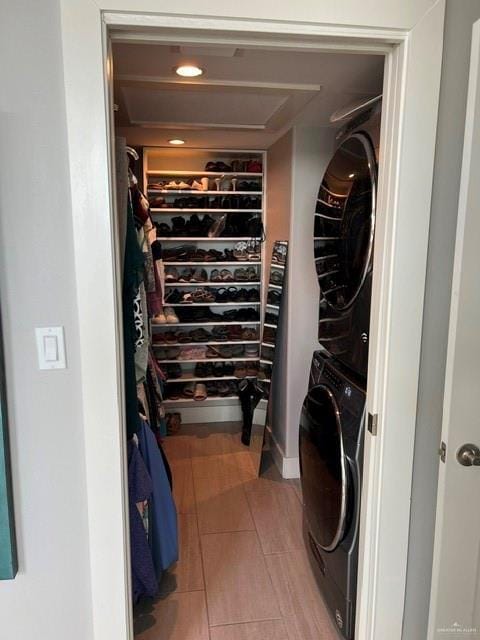 572 Sand Dollar Dr, Port Isabel, TX 78578 - washroom featuring stacked washing machine and dryer and light tile patterned floors