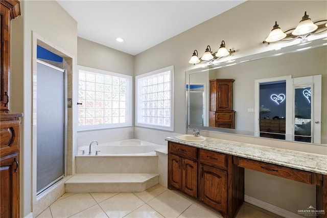 bathroom with tile patterned flooring, shower with separate bathtub, and vanity