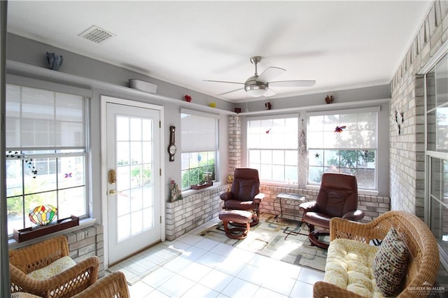 sunroom / solarium featuring ceiling fan and plenty of natural light