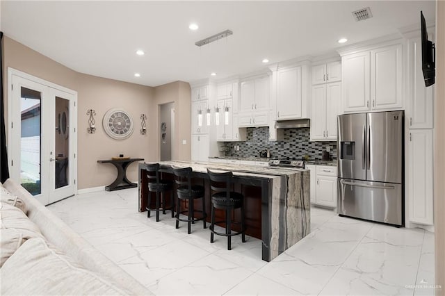 505 N 9th St, Mcallen, TX 78501 - kitchen with appliances with stainless steel finishes, light marble finish floors, recessed lighting, a breakfast bar, and backsplash
