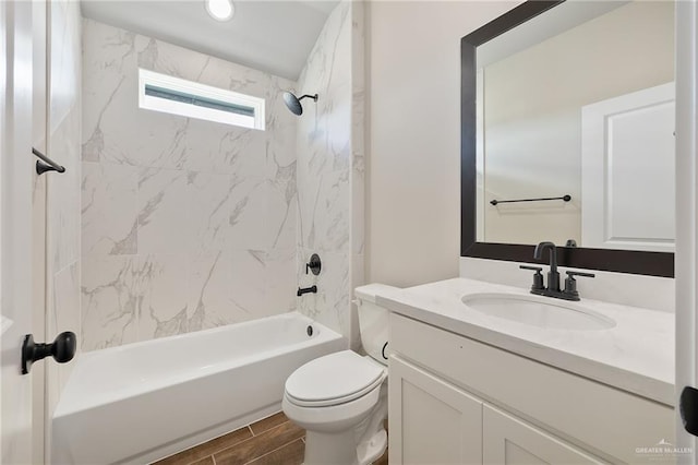 full bathroom with tiled shower / bath combo, vanity, and toilet