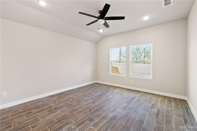 empty room featuring dark wood-type flooring, ceiling fan, and vaulted ceiling