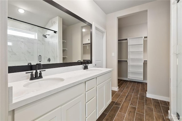 bathroom with vanity and a shower with door