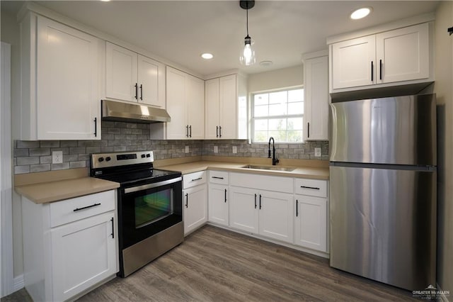 kitchen with wood-type flooring, white cabinetry, sink, and appliances with stainless steel finishes