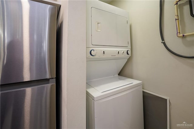 laundry room with stacked washing maching and dryer