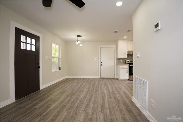 foyer with ceiling fan and wood-type flooring