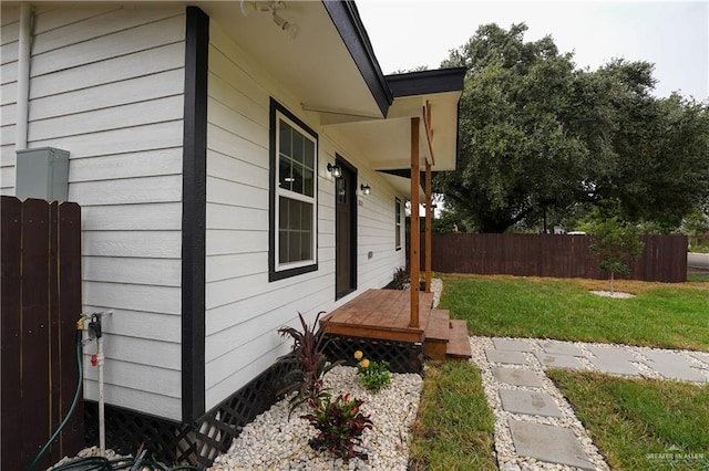 view of side of property with a porch and a yard