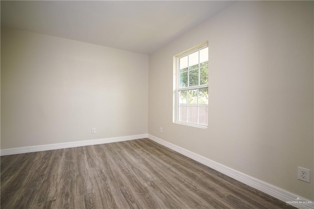 unfurnished room featuring dark wood-type flooring