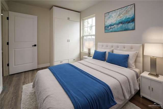 bedroom with dark wood-type flooring