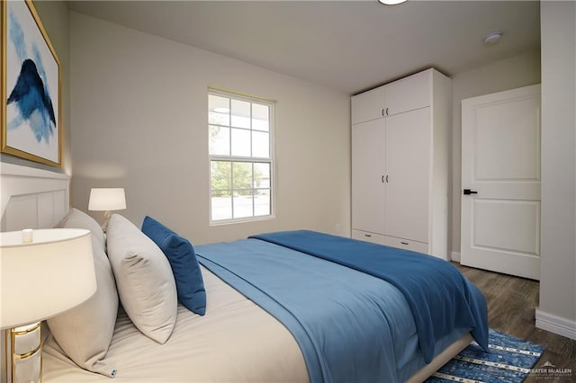 bedroom featuring dark wood-type flooring