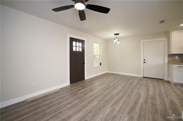 entryway with ceiling fan and light hardwood / wood-style flooring