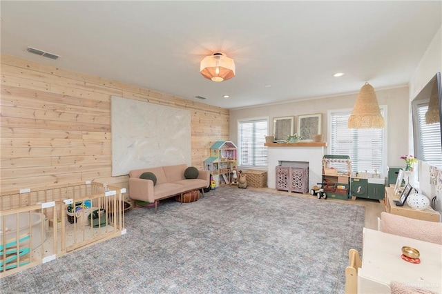 1011 W Orange St, Mcallen, TX 78501 - living area with wooden walls, a fireplace, and carpet floors