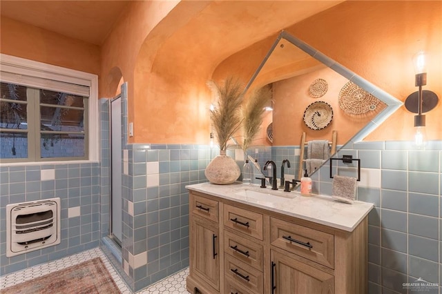 1011 W Orange St, Mcallen, TX 78501 - bathroom with tile walls, tile patterned floors, heating unit, vanity, and an enclosed shower