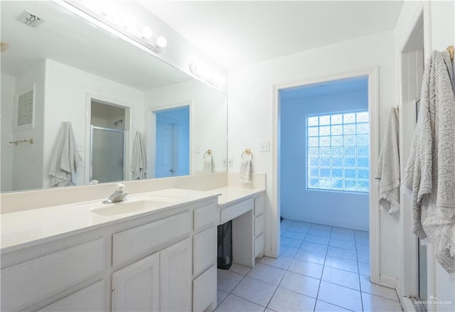 bathroom featuring an enclosed shower, vanity, and tile patterned floors