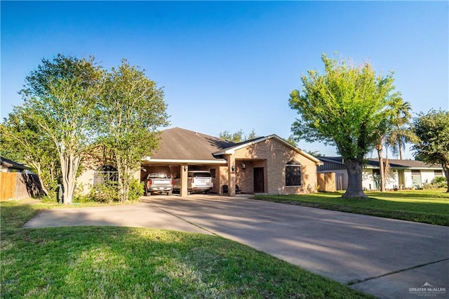 view of front of property with a front lawn and a carport