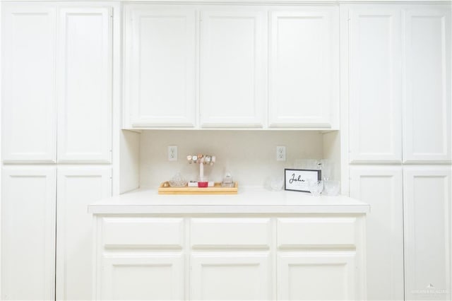 bar featuring white cabinetry