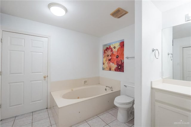 bathroom with toilet, tile patterned flooring, a washtub, and vanity