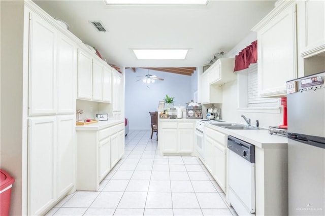 kitchen with white dishwasher, white cabinetry, stainless steel fridge, and ceiling fan