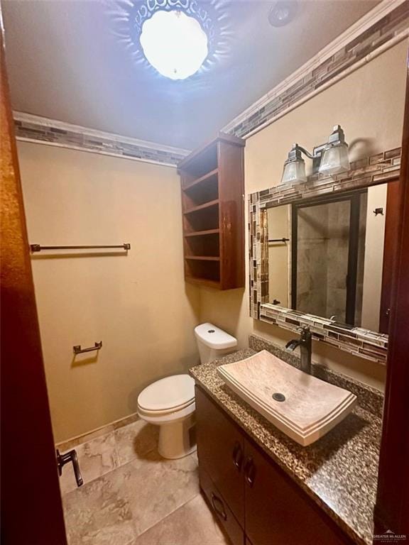 bathroom featuring vanity, toilet, and crown molding