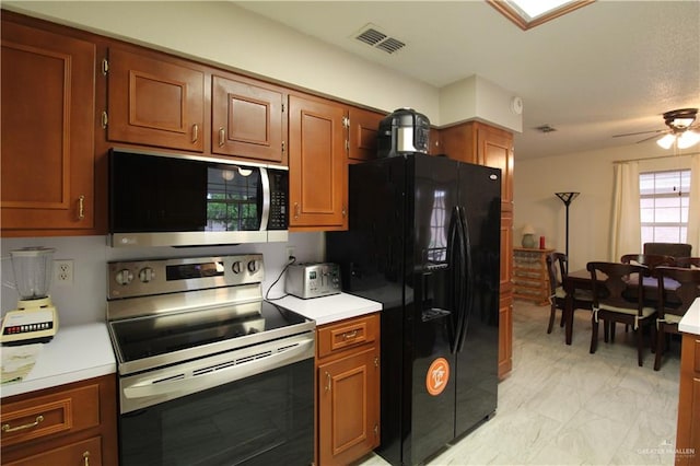 kitchen with ceiling fan and appliances with stainless steel finishes