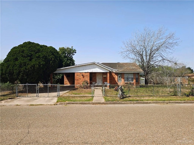 view of front of home featuring a fenced front yard, brick siding, and a gate