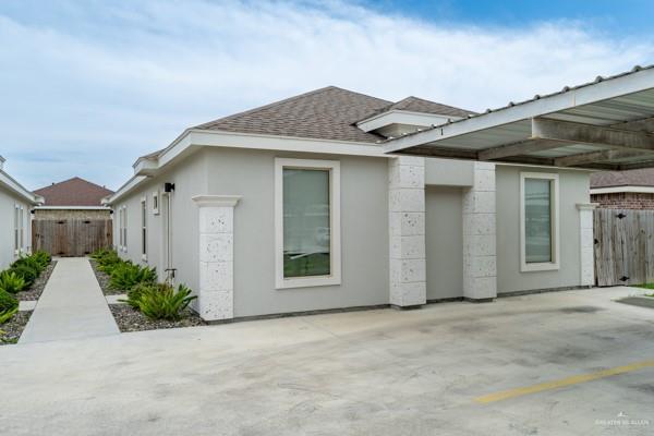 1009 W La Pointe Ave, Mission, TX 78573 - view of property exterior featuring roof with shingles and stucco siding