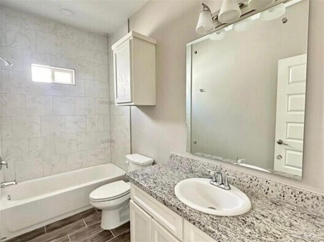 1009 W La Pointe Ave, Mission, TX 78573 - bathroom featuring toilet, vanity, bathing tub / shower combination, and wood tiled floors