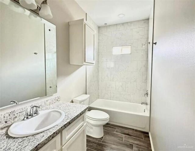1009 W La Pointe Ave, Mission, TX 78573 - bathroom with vanity, toilet, wood tiled floors, and bathing tub / shower combination